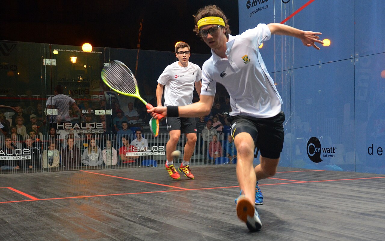 Junior players competing on a glass court